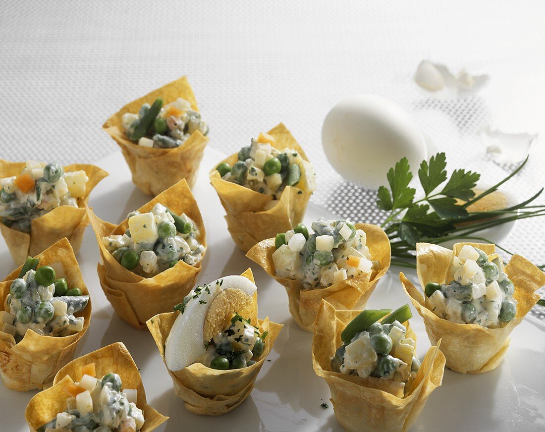 Vegetable salad with boiled egg in filo pastry shells