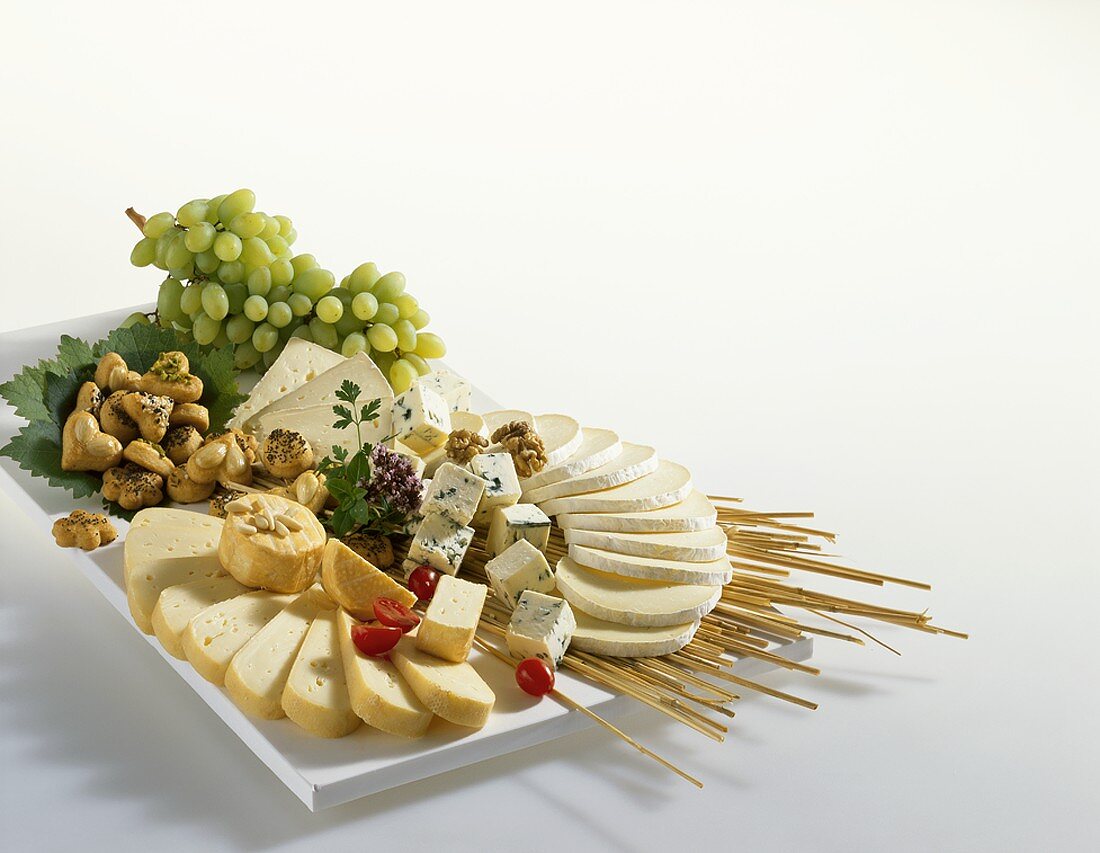 Cheese platter with biscuits and grapes