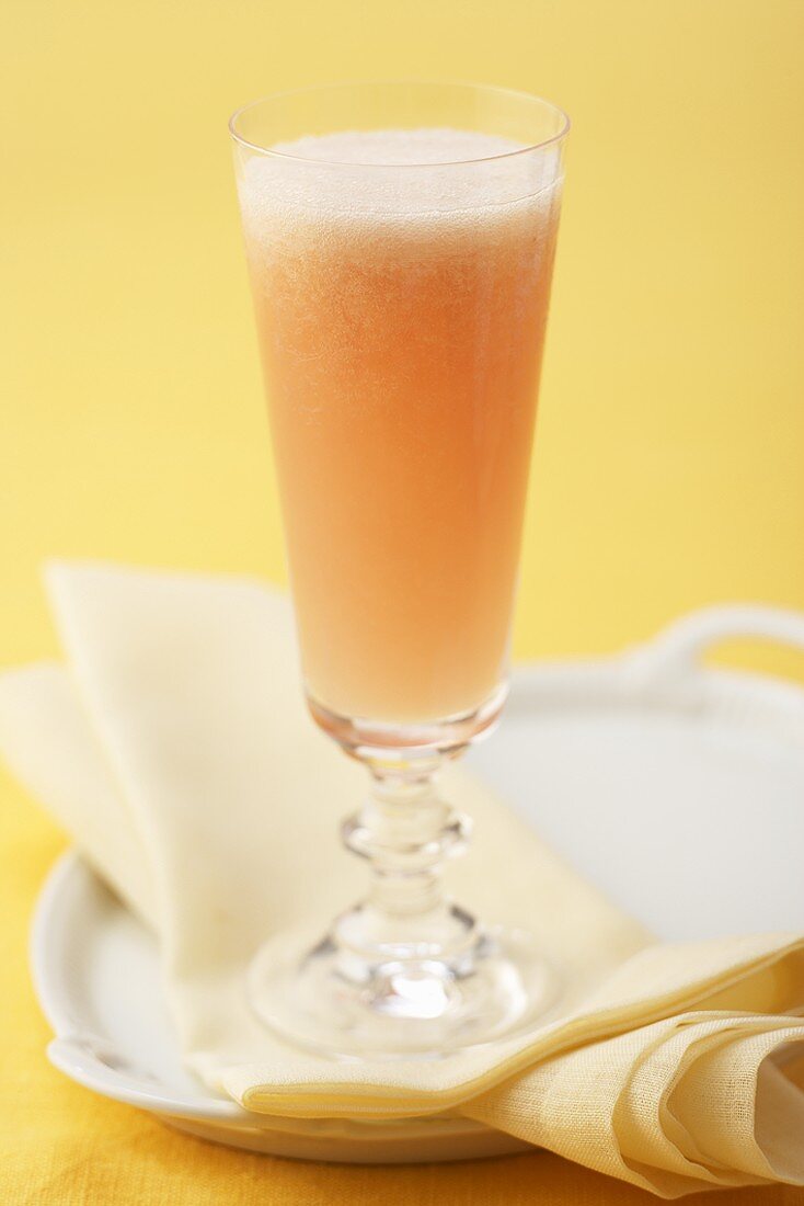Bellini (cocktail of sparkling wine & peach puree) in glass