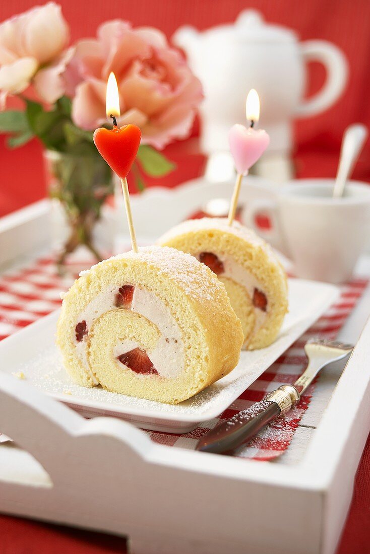 Sponge roll with strawberry filling and two candles
