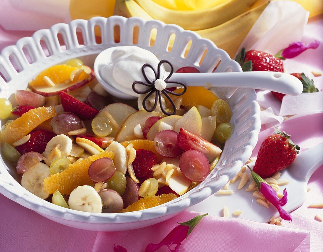 Fruit salad with slivered almonds and cream