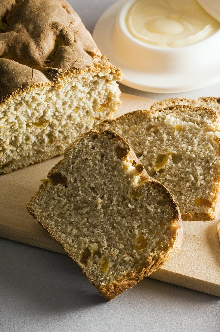 Chestnut and apricot bread, partly sliced, butter