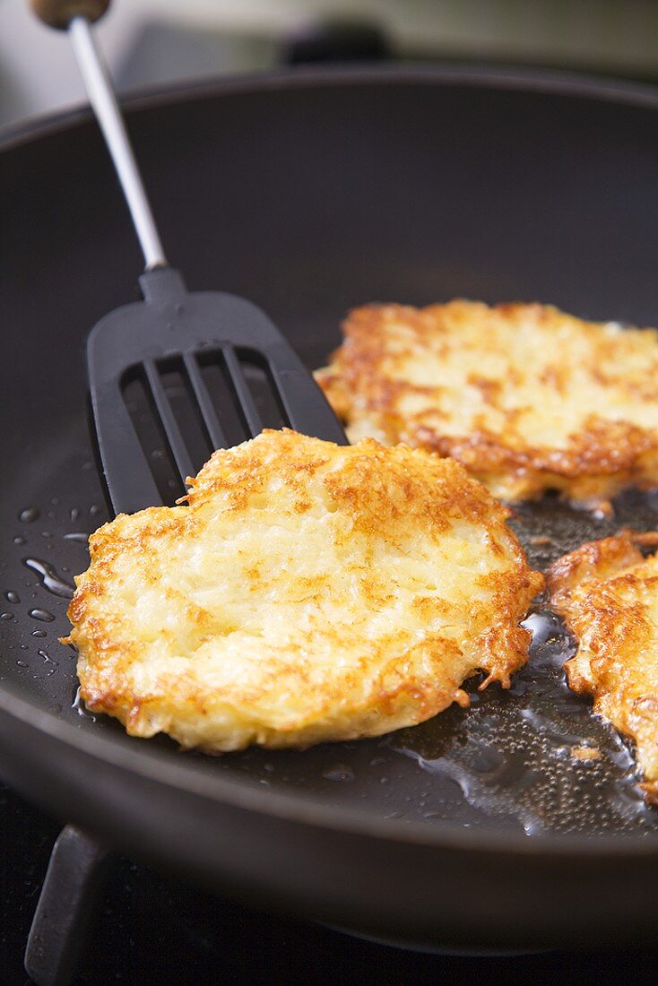 Frying potato rosti in frying pan