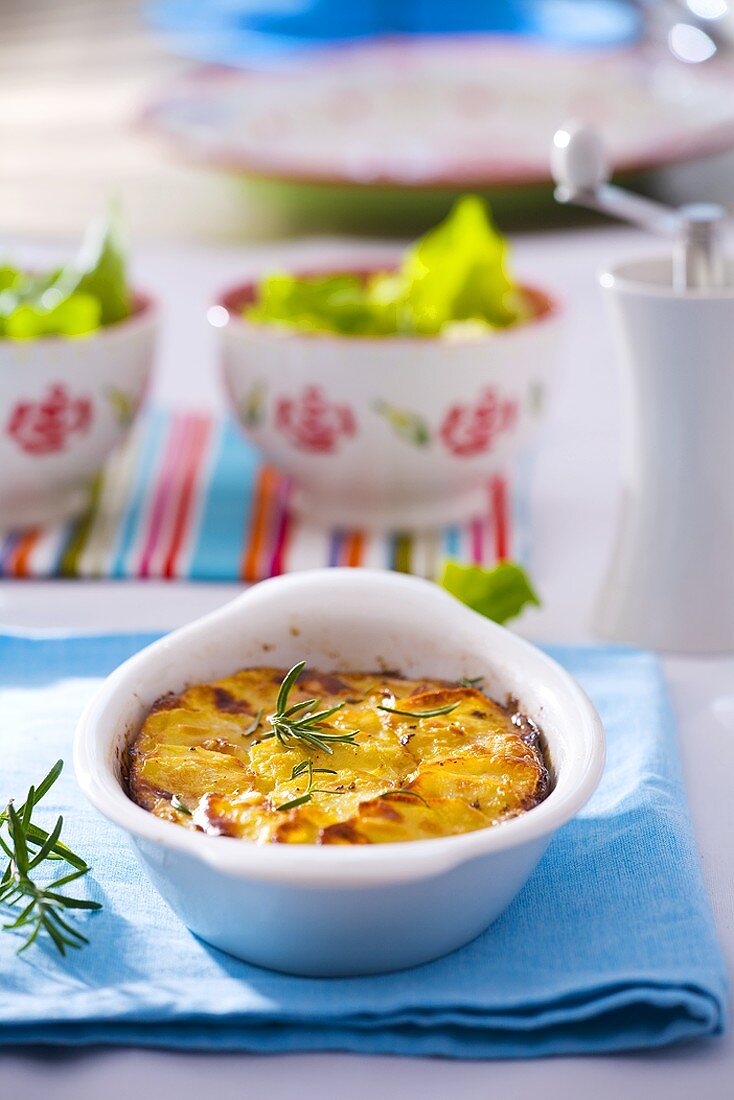 Potato gratin with rosemary in baking dish