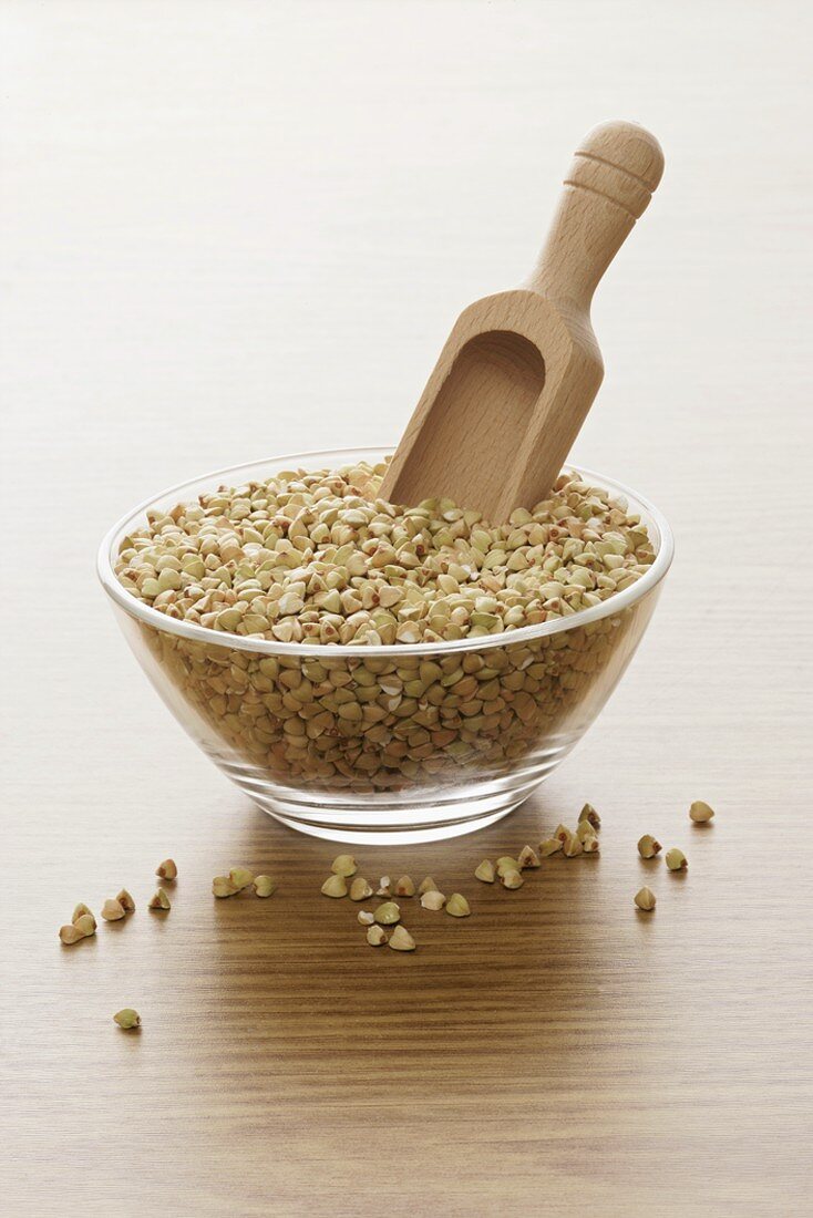 Buckwheat in glass bowl with scoop