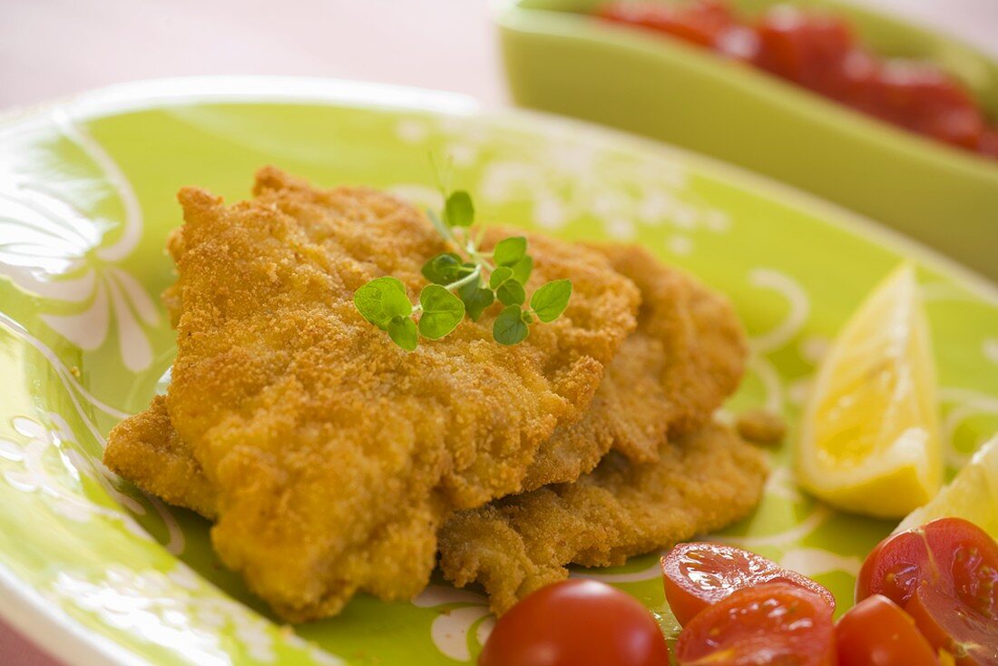 Deep-fried fish fillets with cherry tomatoes