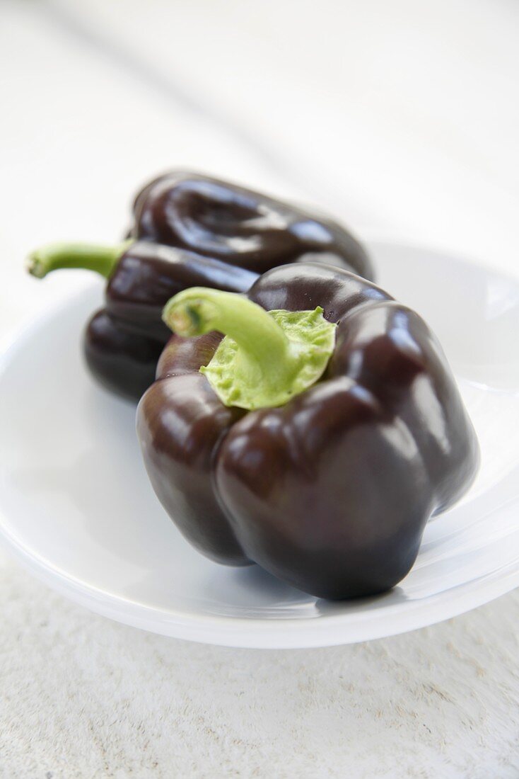 Purple peppers on white plate