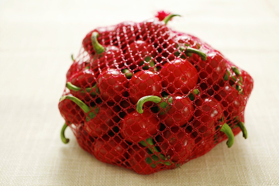 Cherry peppers in a red net