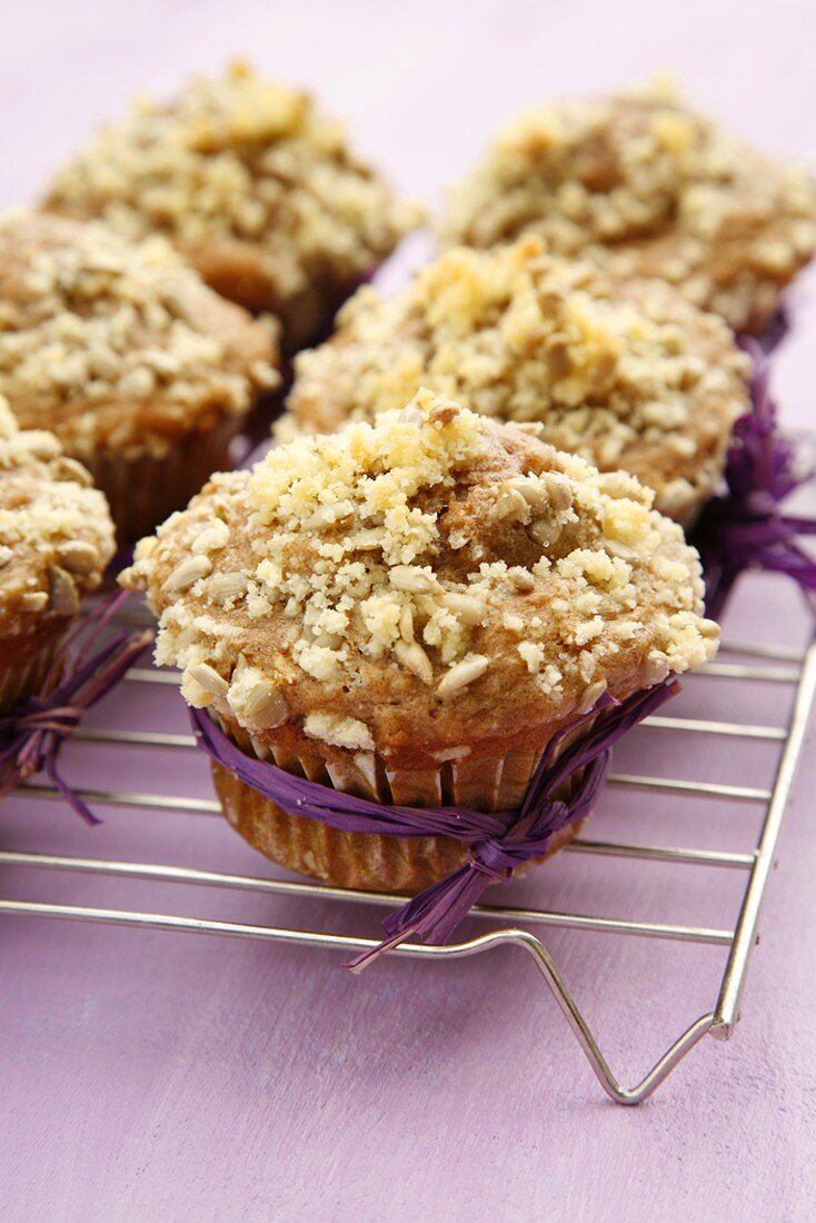 Apple muffins with sunflower seeds on cake rack