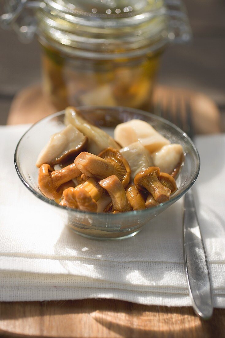 Pickled mushrooms in glass dish