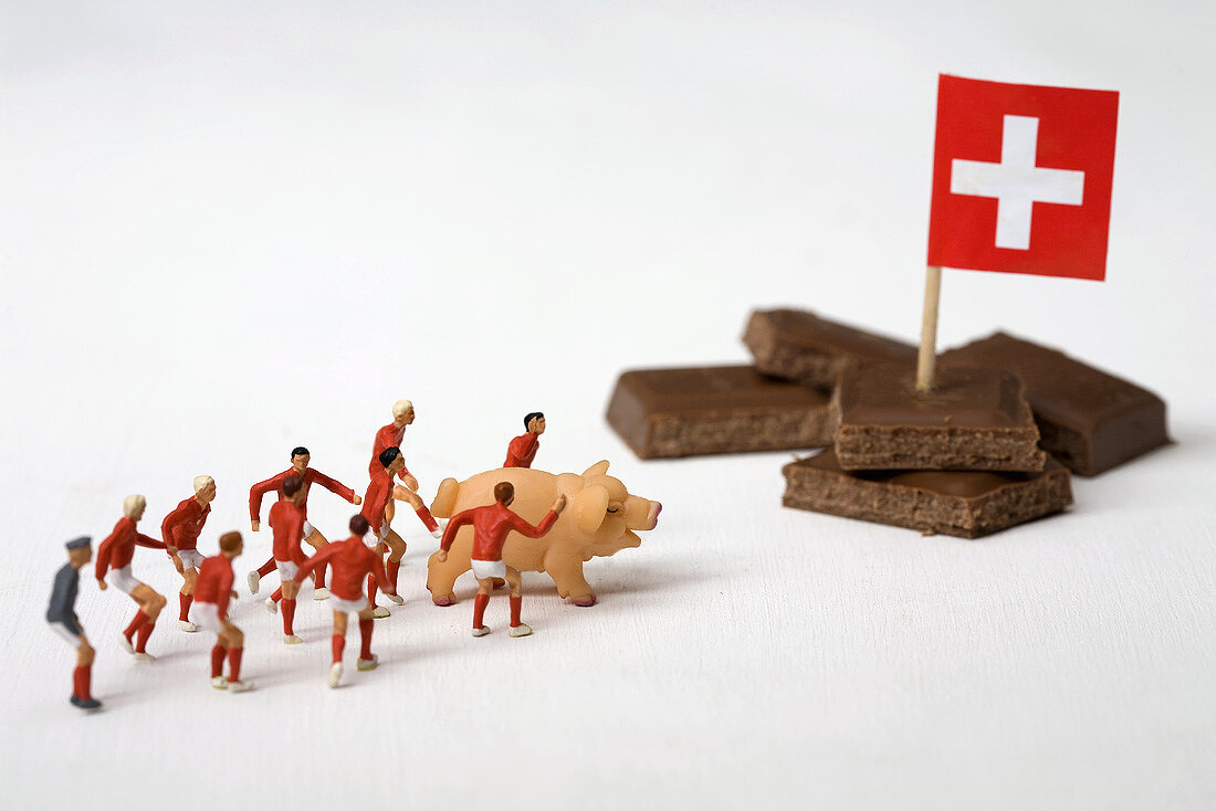 Pieces of chocolate, Swiss flag, toy footballers, pig