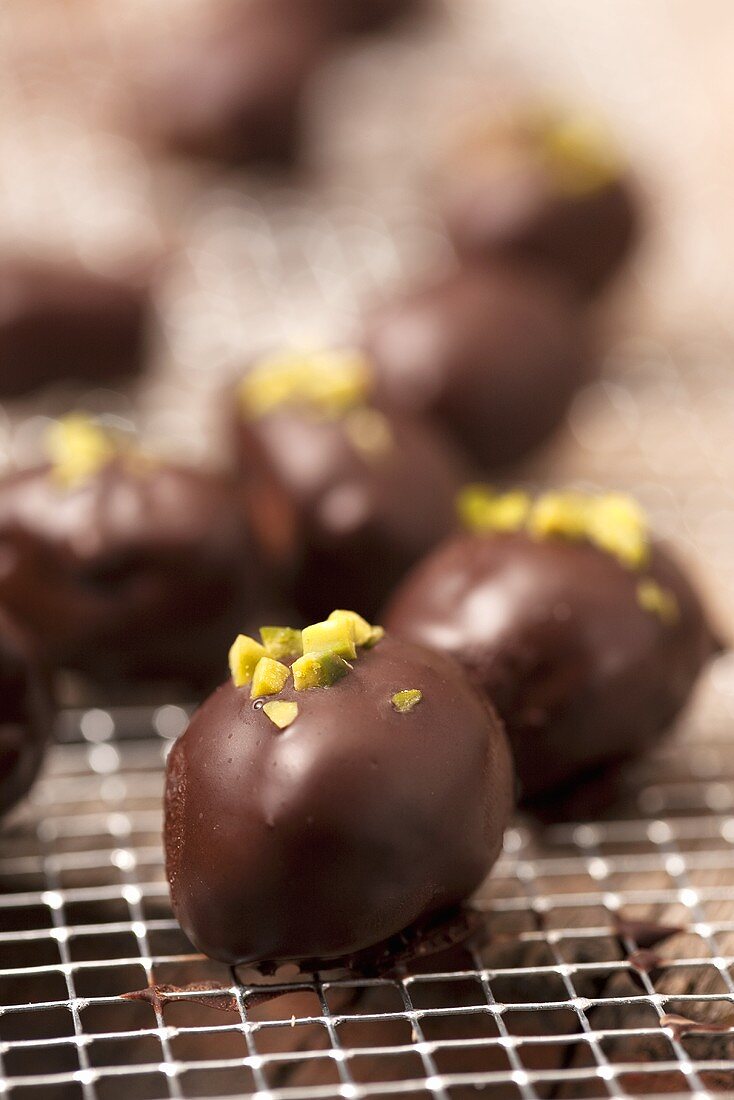 Chocolate coated marzipan pralines with pistachios