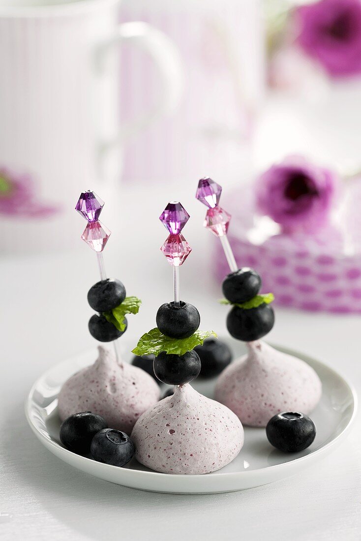 Raspberry meringues with blueberries and lemon balm