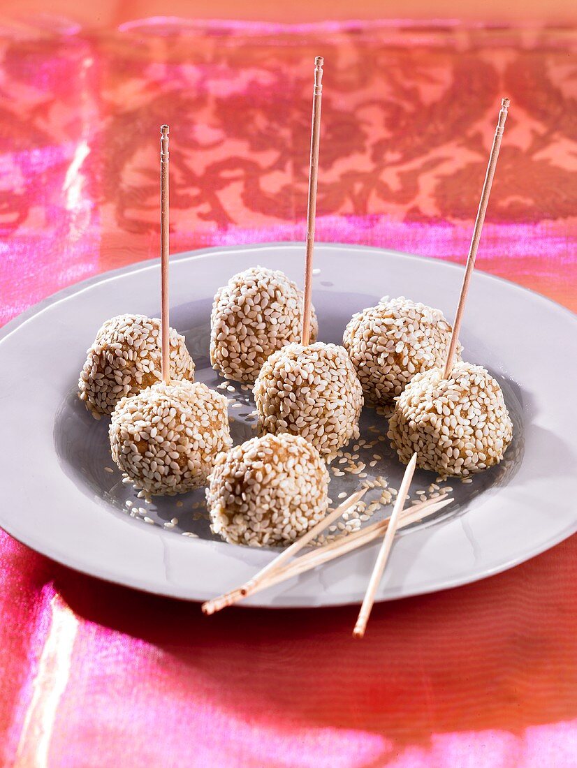 Walnut and sesame seed balls on toothpicks