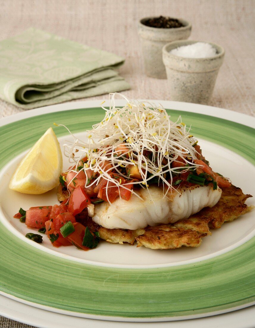 Poached fillet of fish with napoletana sauce on sweet potato hash browns