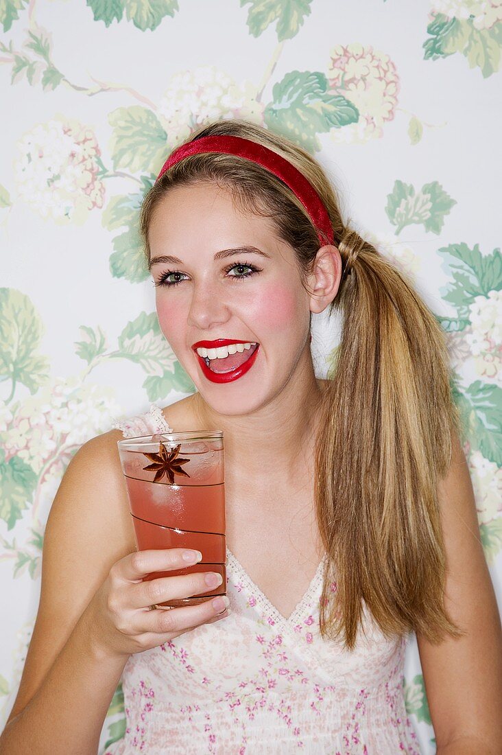 A girl drinking a plum cocktail