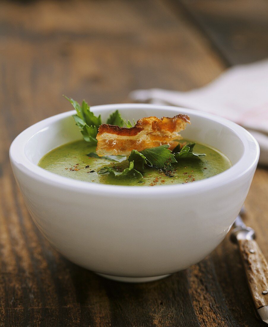 Green potato and celery soup with strips of bacon