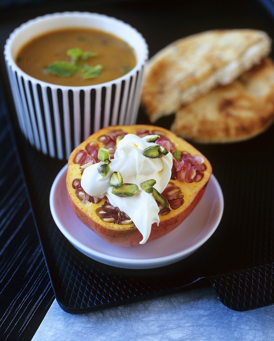 Lentil soup with flatbread and pomegranate with crème fraîche