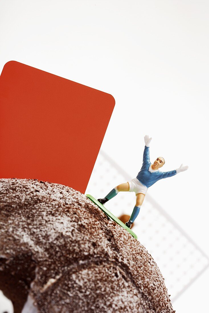 Football cake with player and red card