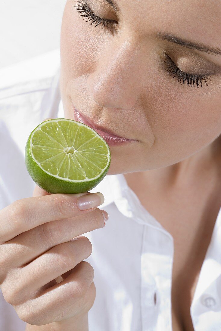 Young woman with half a lime