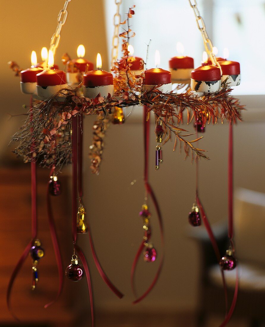 Hanging wreath with candles and tree ornaments