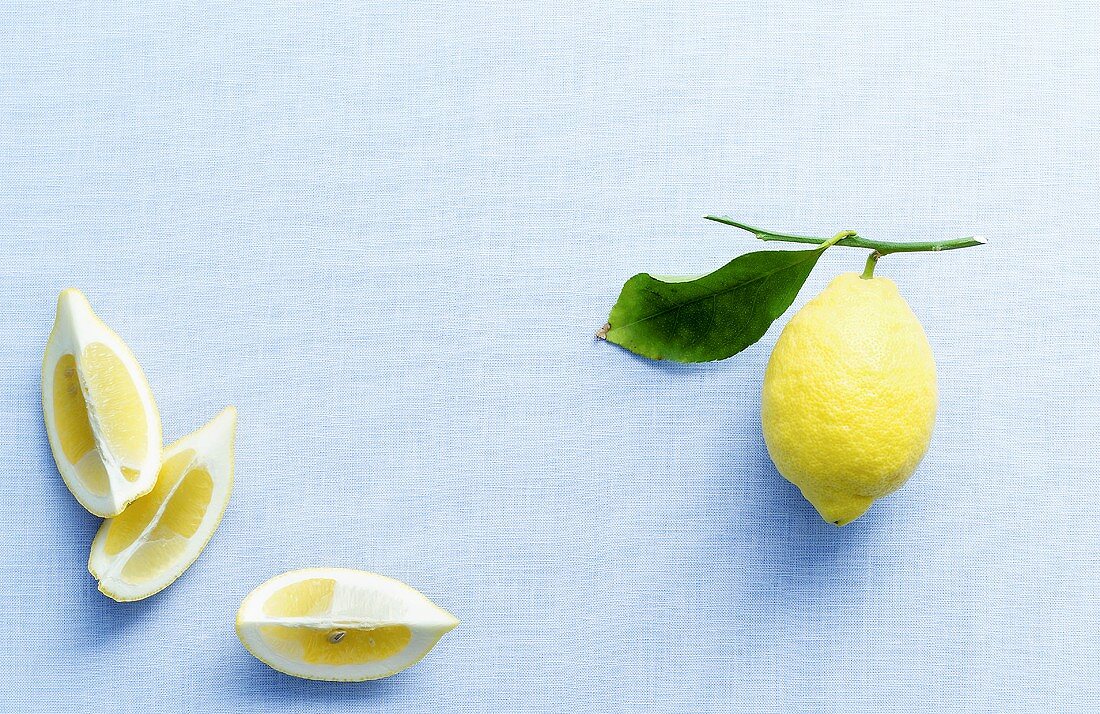 Lemon wedges and lemon with leaf