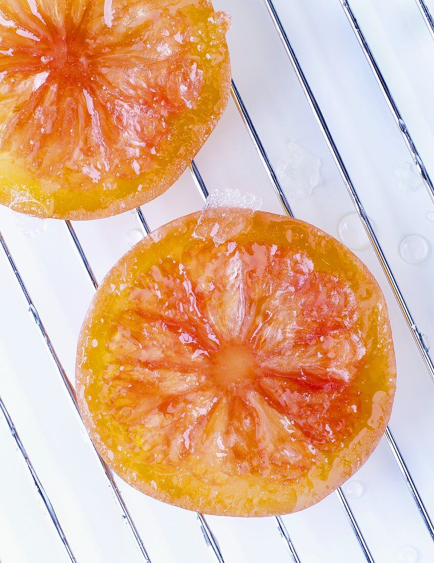 Candied citrus fruit slices on draining rack