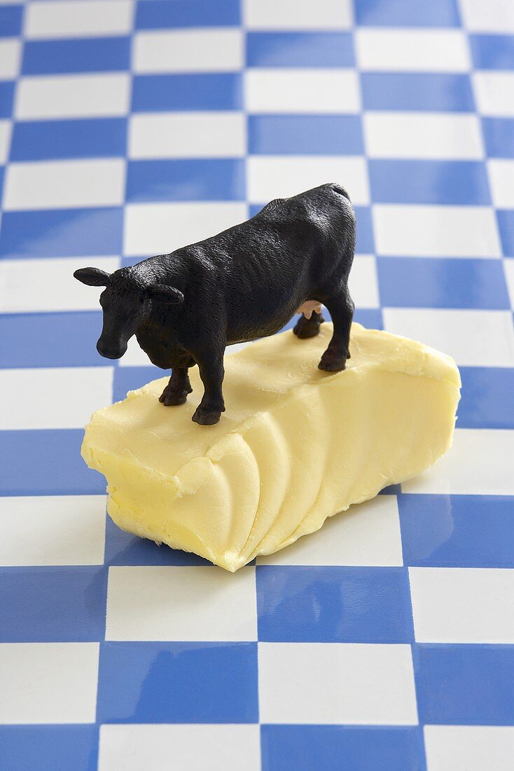 Piece of butter with model cow