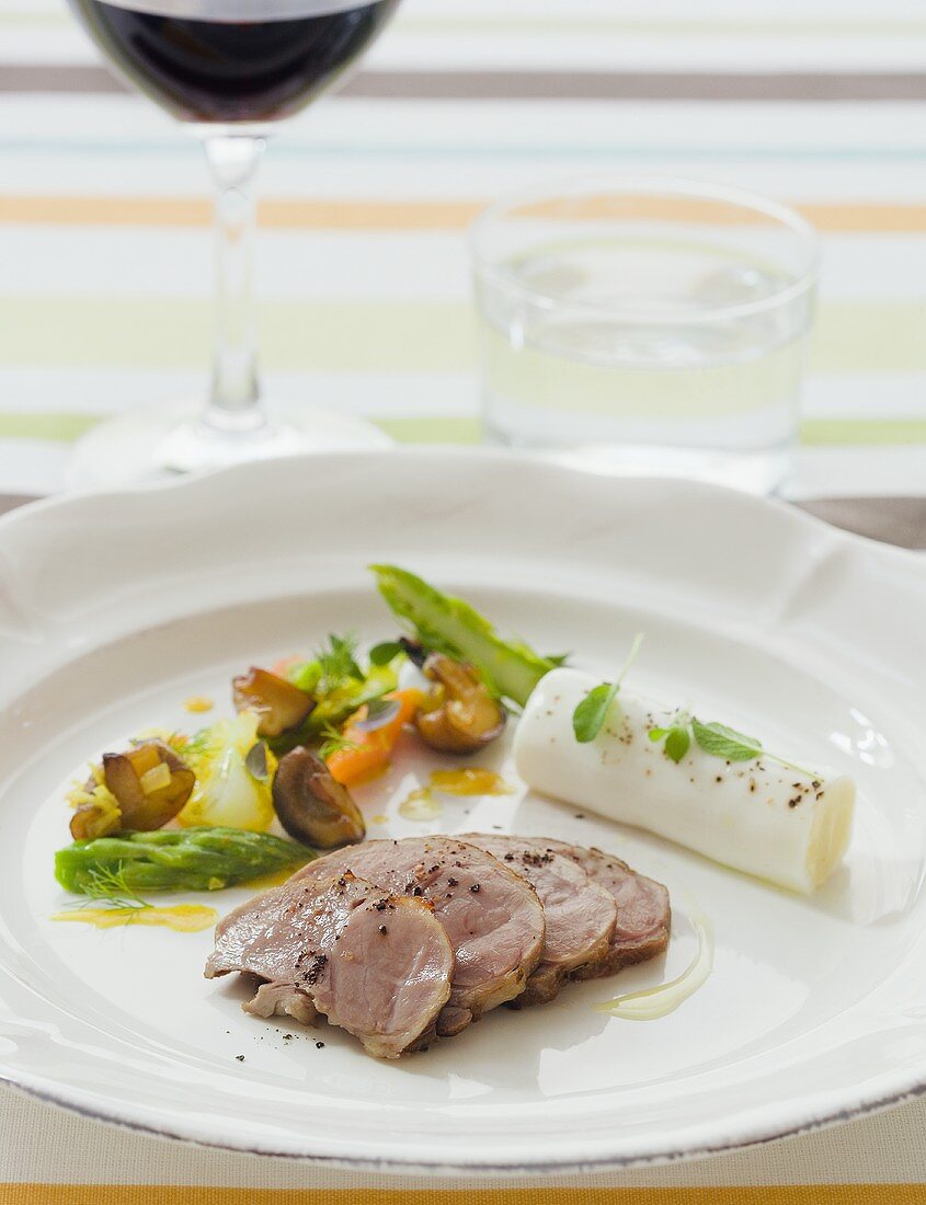 Lamb fillet with young vegetables and soft cheese roll