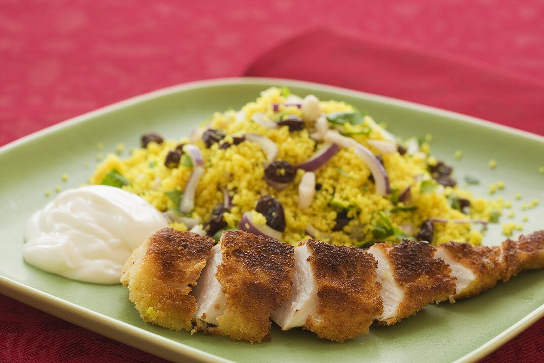 Breaded chicken breast with couscous and sour cream