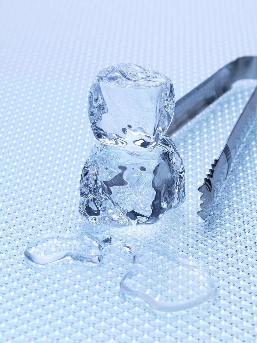 Two ice cubes with ice tongs