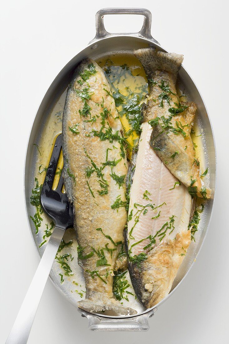 Two trout roasted in olive oil