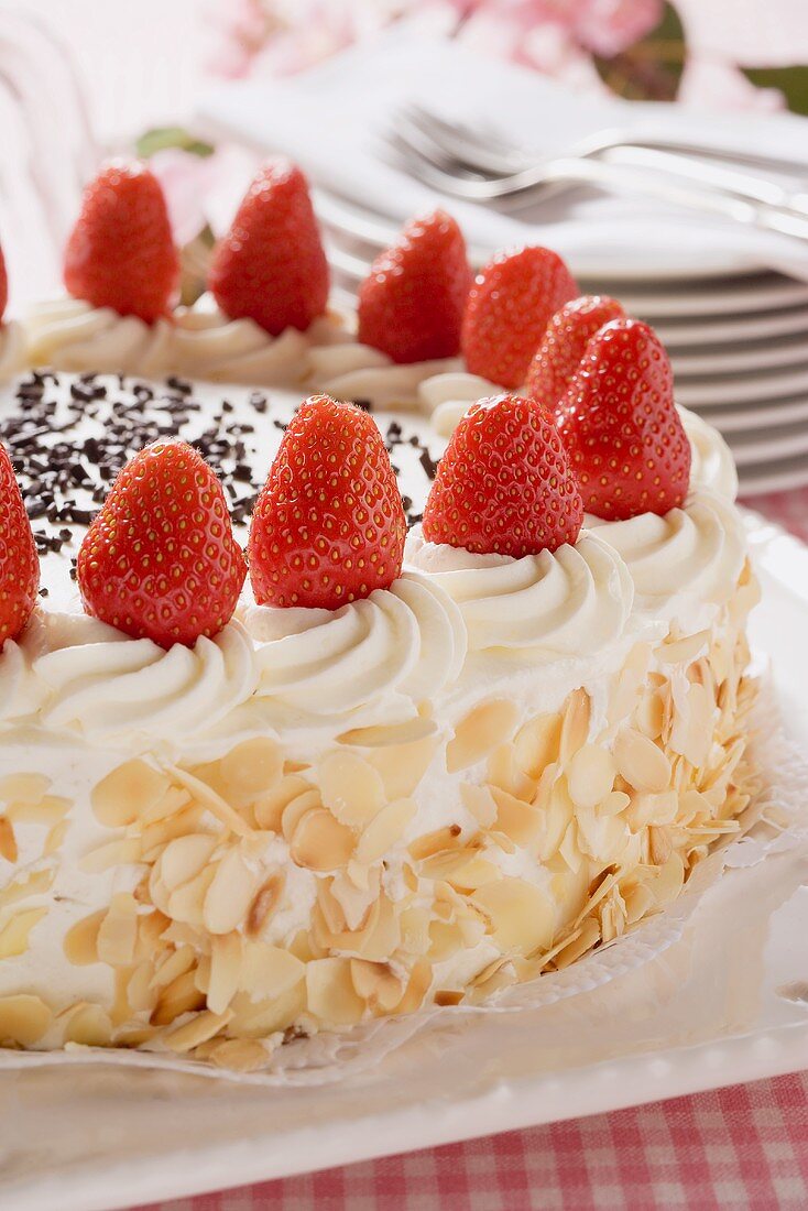 Strawberry cream cake with flaked almonds (detail)