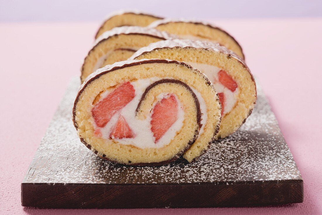 Sponge roll with chocolate icing and strawberry filling