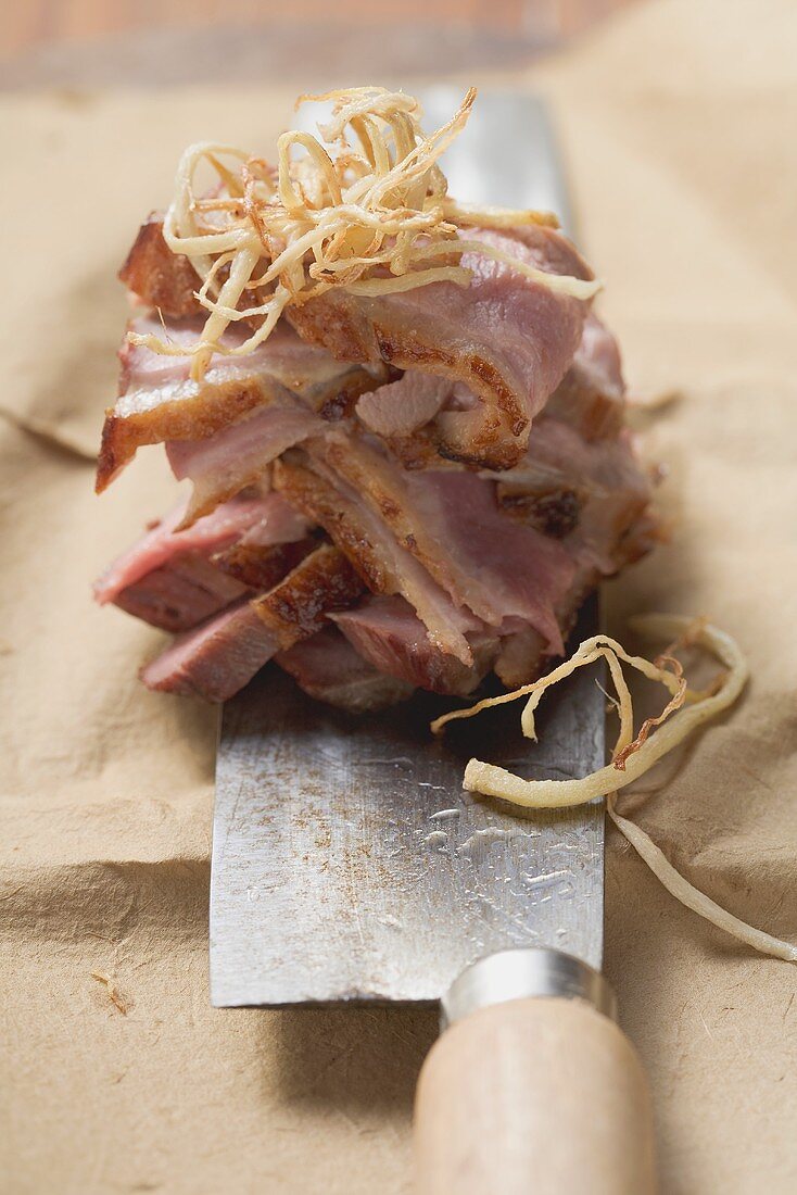 Duck breast with sprouts on knife (Asia)