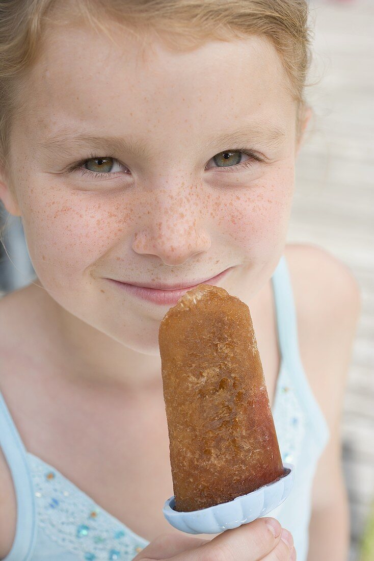 Girl holding an ice lolly