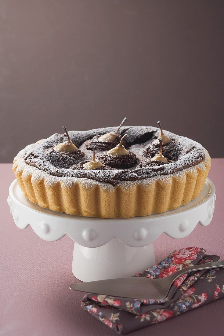 Pear and chocolate tart on cake stand