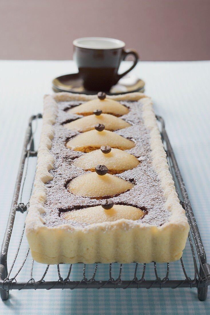 Pear and chocolate tart with mocha beans, espresso cup