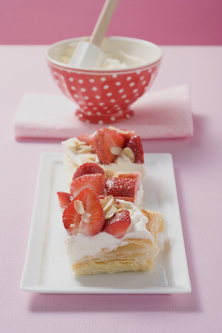 Several puff pastry slices with strawberries & cream