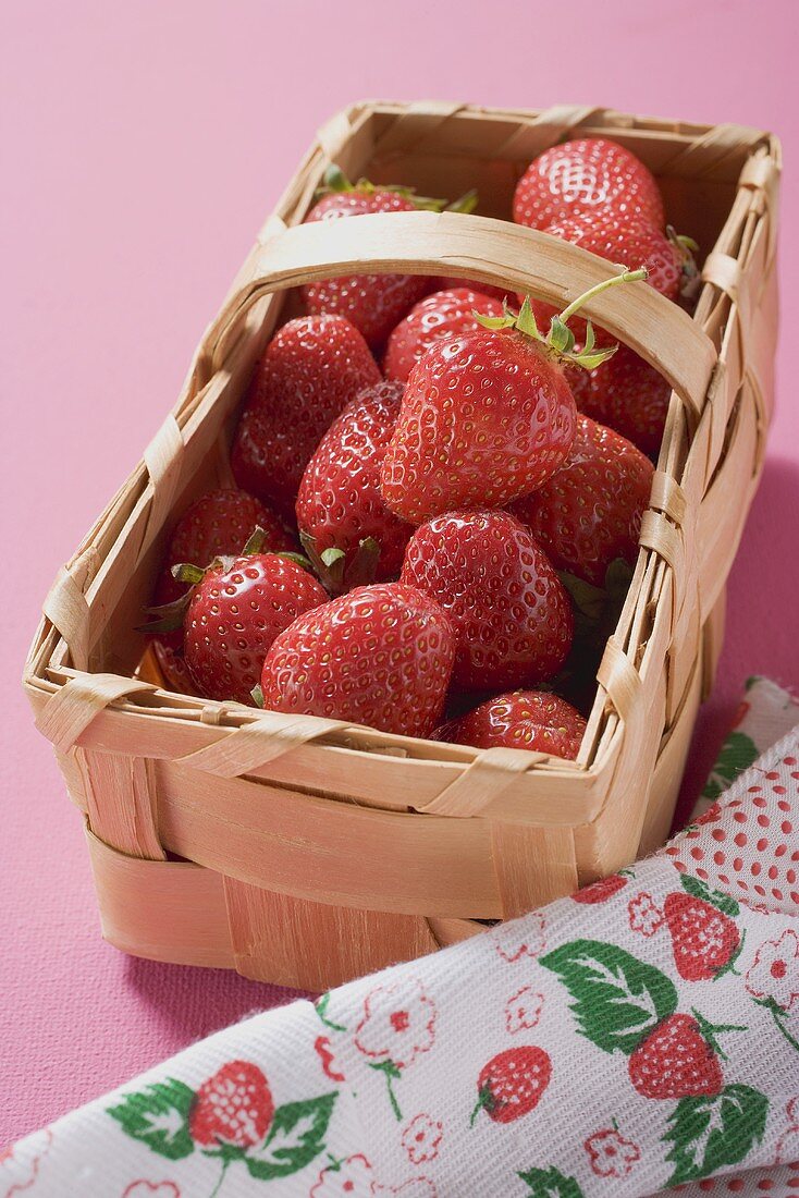 Fresh strawberries in a woodchip basket