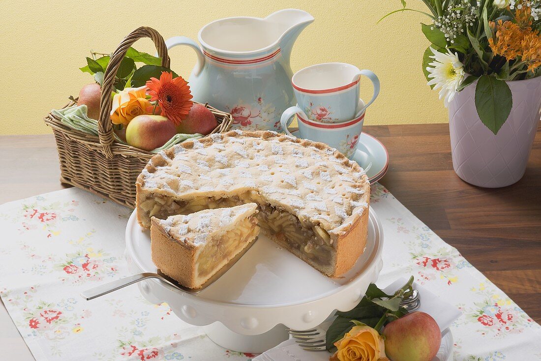 Apple pie, a piece cut, fresh apples, coffee cups