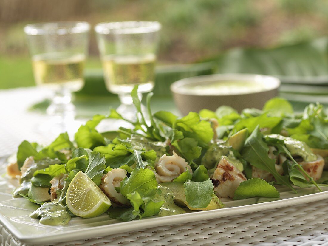 Salad leaves with grilled squid on a table out of doors