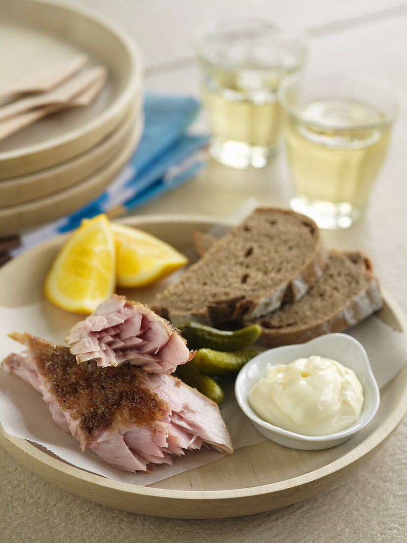 Räucherfisch mit Mayonnaise, Essiggurken und Brot