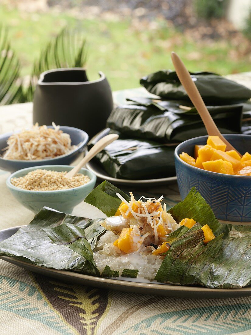 Sticky rice with diced mango in banana leaves