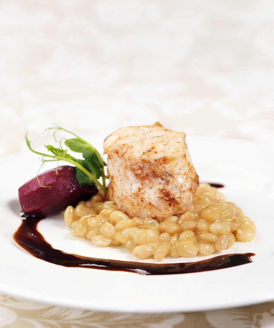 Grilled fish fillet with white beans and red wine sauce