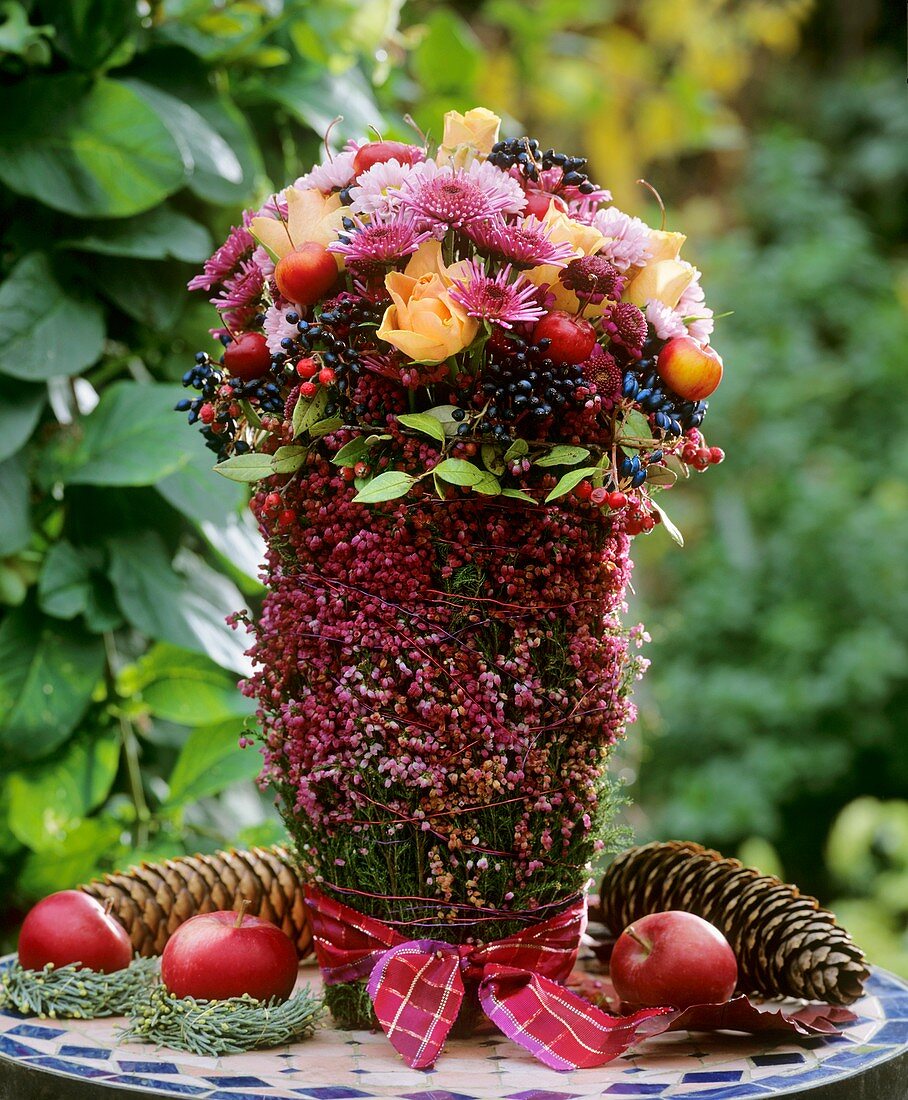 Arrangement of roses, chrysanthemums, privet berries, Malus