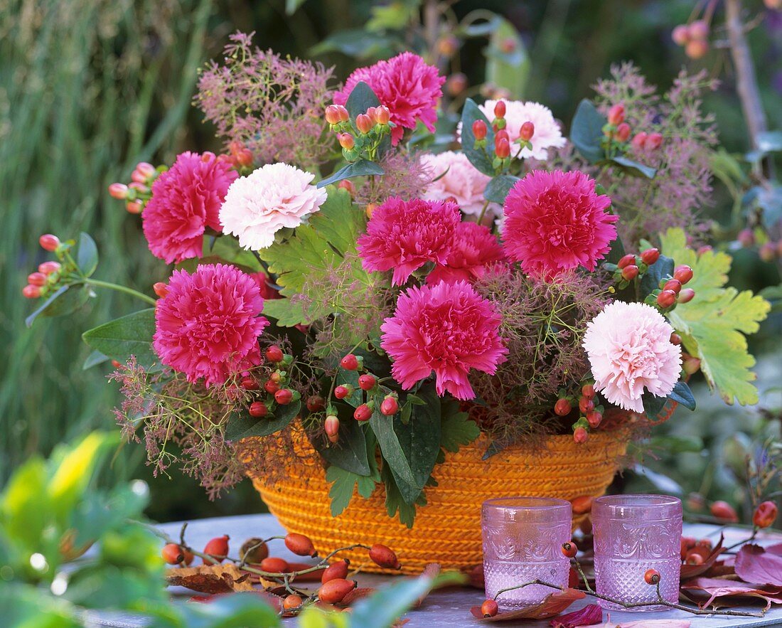 Arrangement of carnations and smoke tree flowers in basket