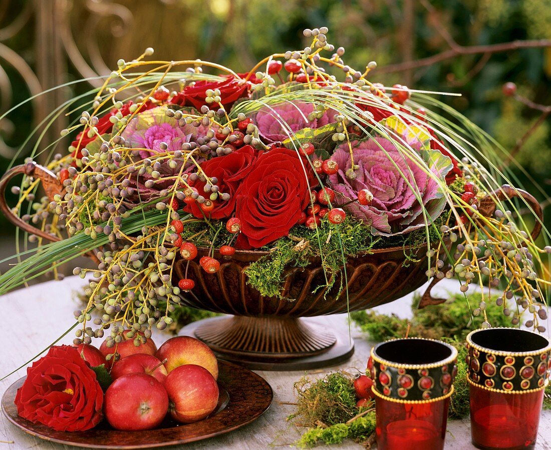 Arrangement of red roses, ornamental cabbage & privet berries
