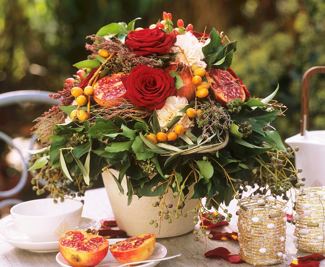 Autumn arrangement of roses, pomegranates and dates