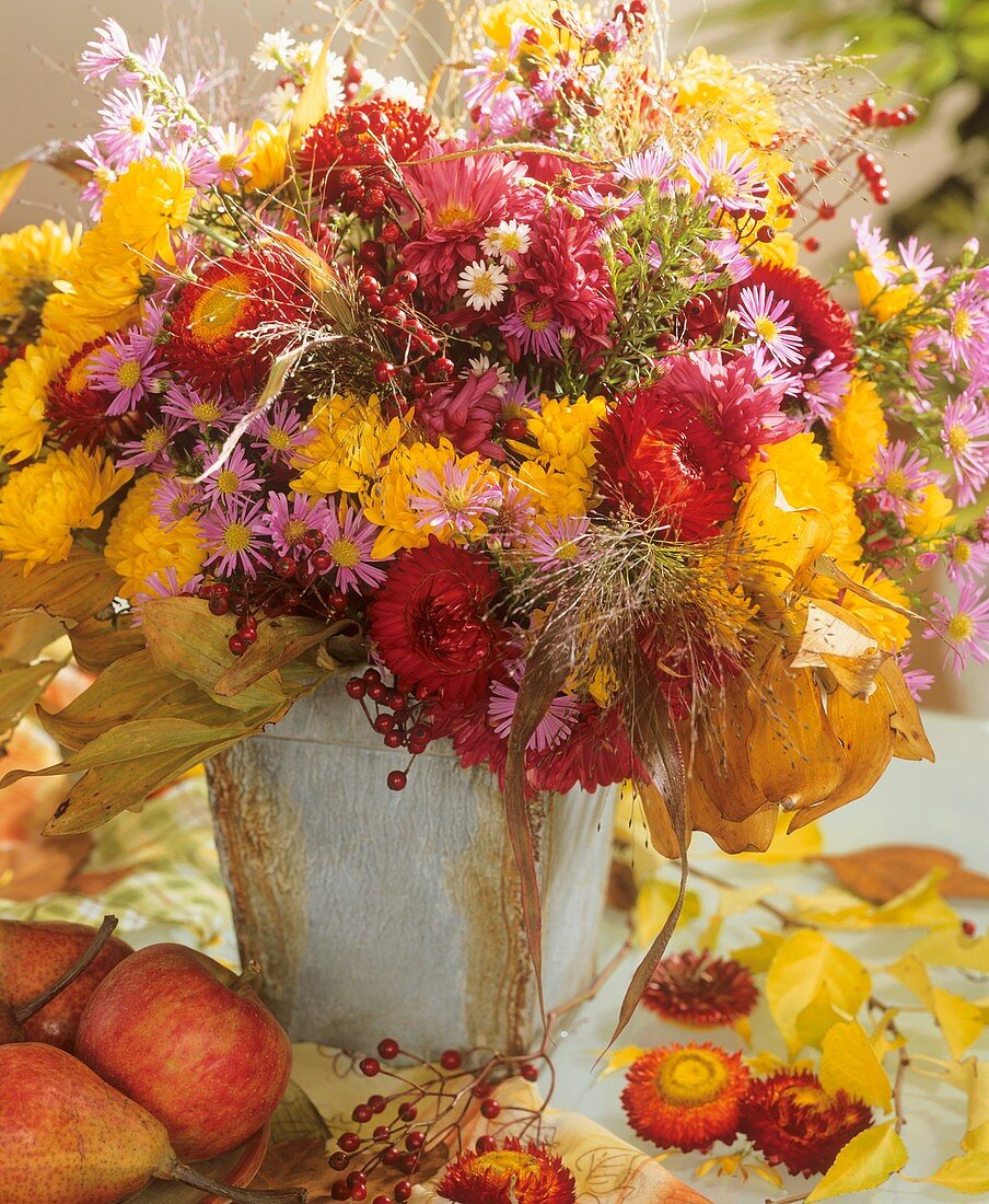 Arrangement of chrysanthemums, straw flowers and asters